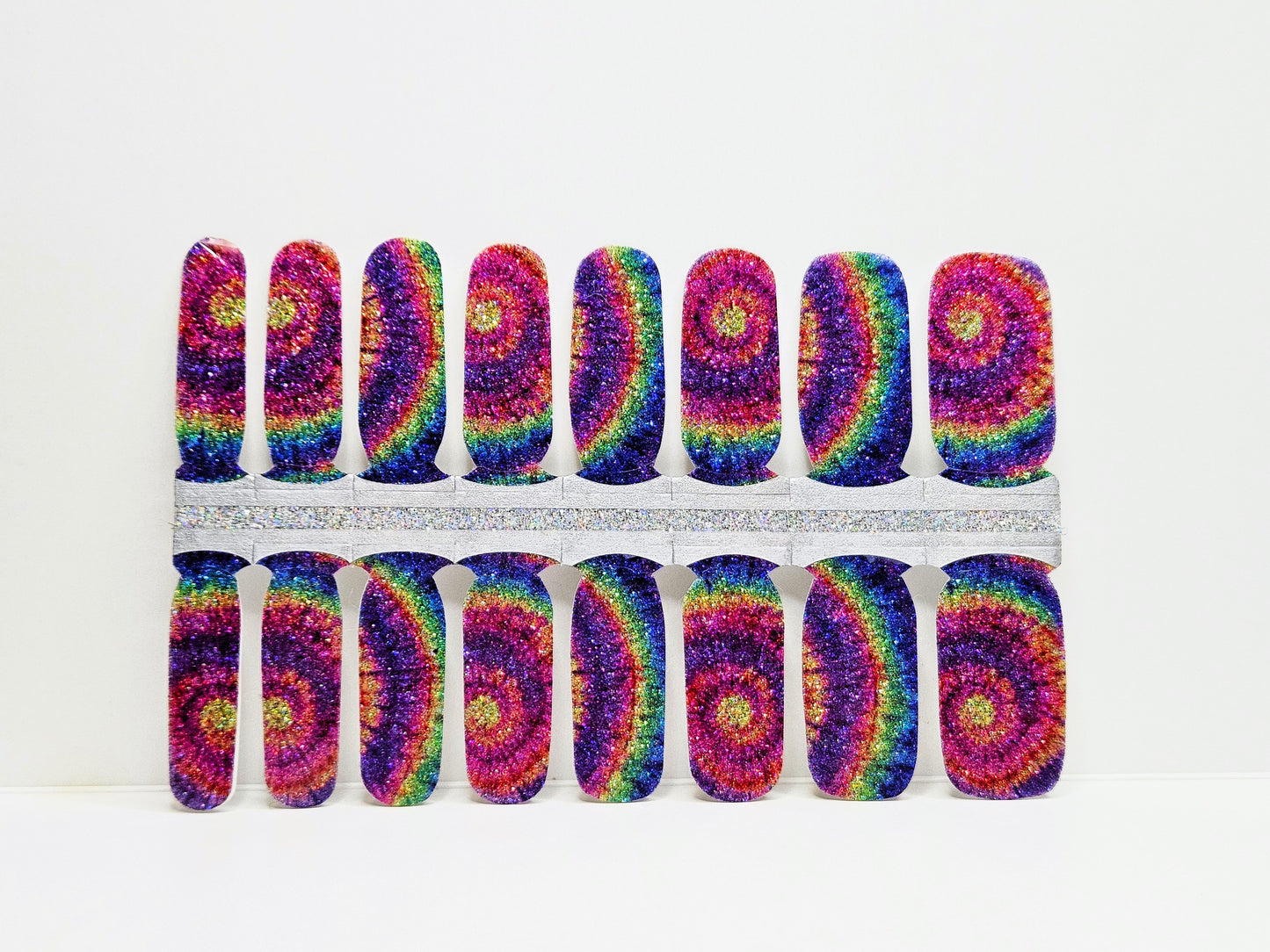 Set of colorful tie-dye nail wraps on a white background
