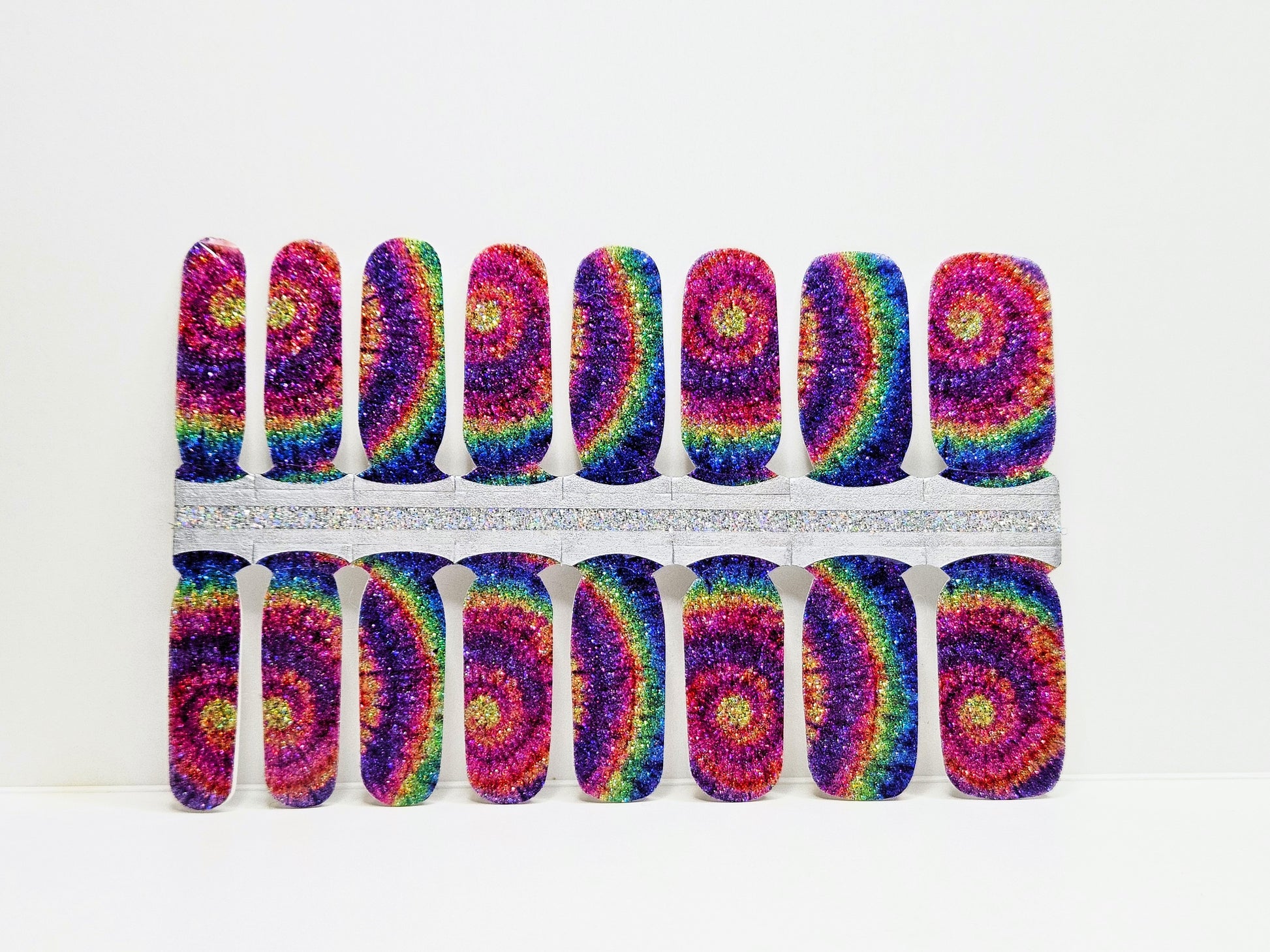 Set of colorful tie-dye nail wraps on a white background