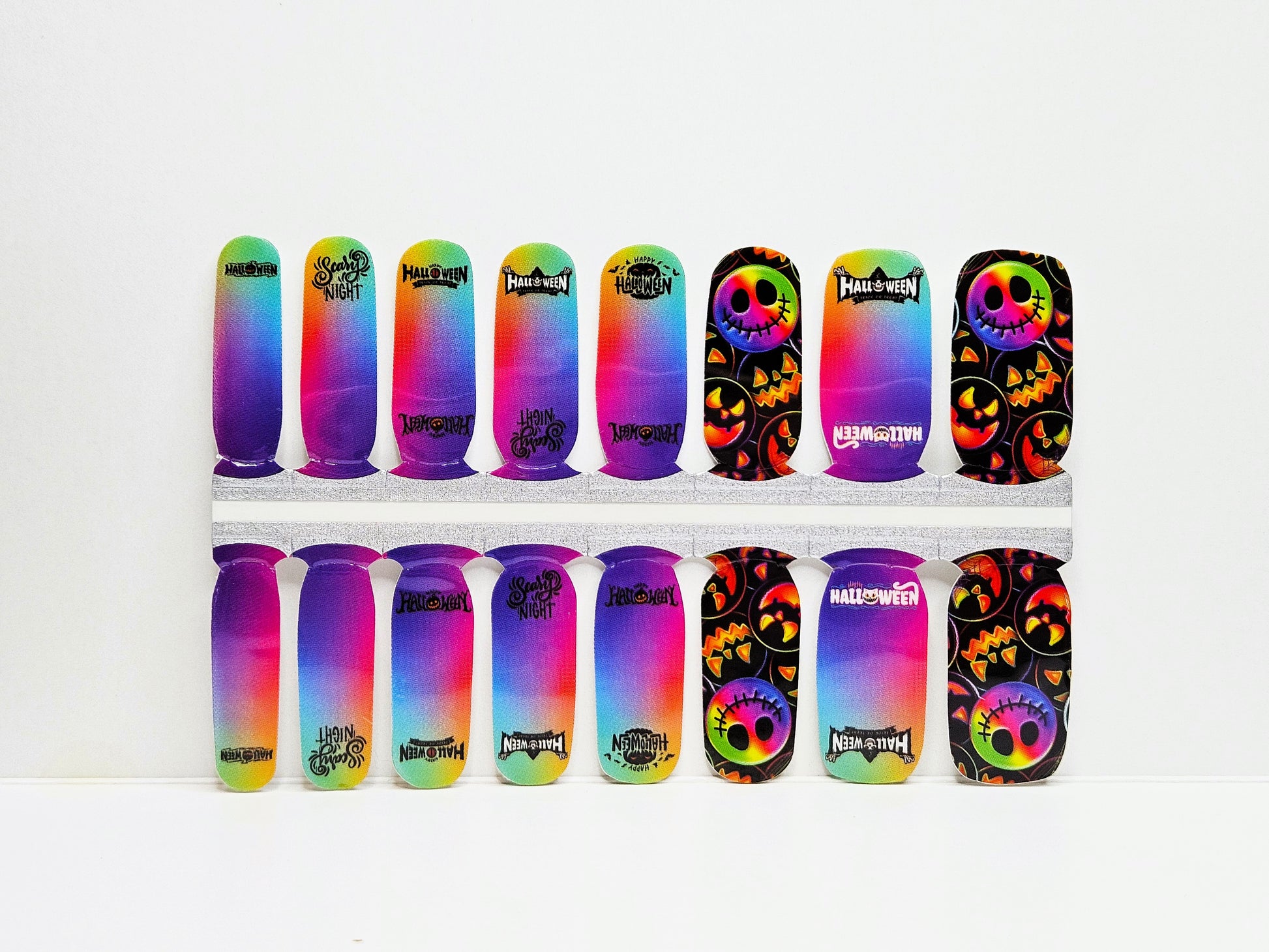 Colorful nail wraps with Halloween designs on a white background
