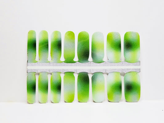Green and white aurora nail wraps against a white background
