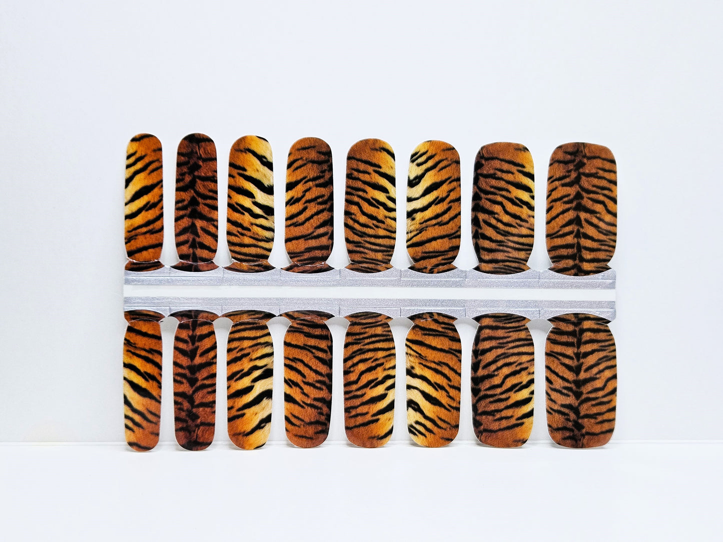 Set of nails with tiger stripe pattern on a white background
