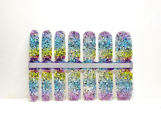 Set of rainbow glittery nail wraps against a white background