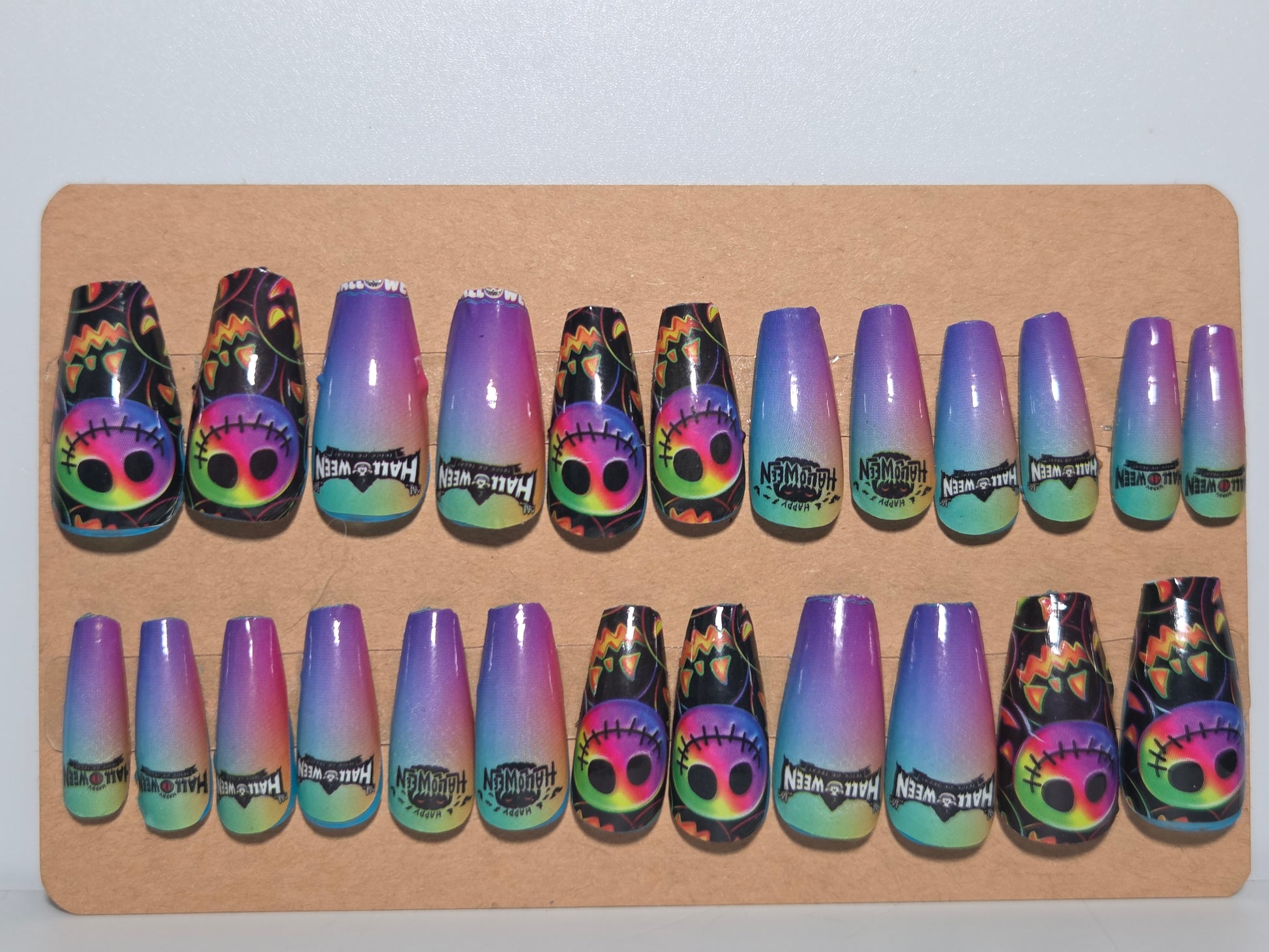 Set of colorful nail wrap designs on a piece cardboard