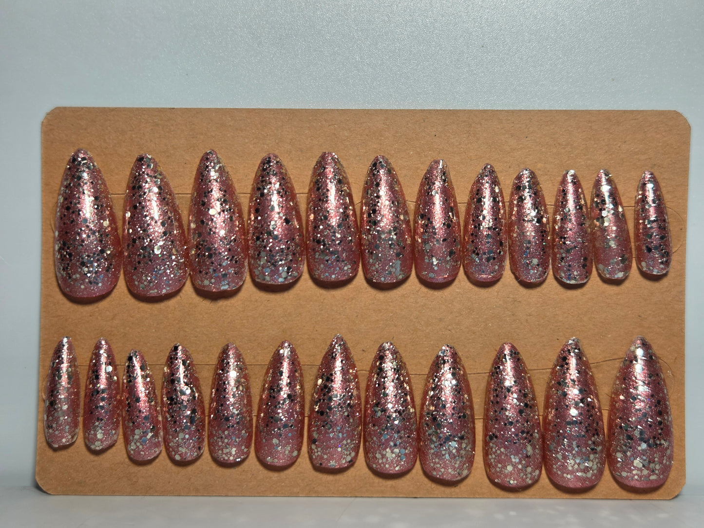 Set of Golden rose  glittery hand made press on nails on a cardboard display.