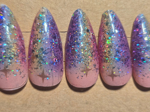 Set of glittery false nails with a gradient effect on a cardboard display